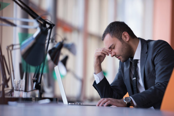 happy young business man portrait in bright modern office indoor