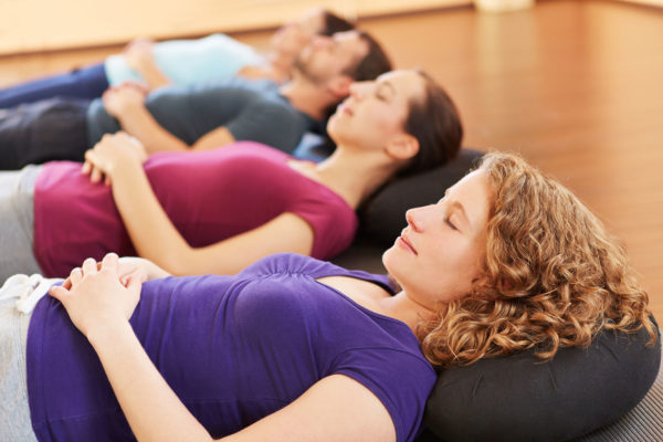 Young group relaxing together in a fitness center